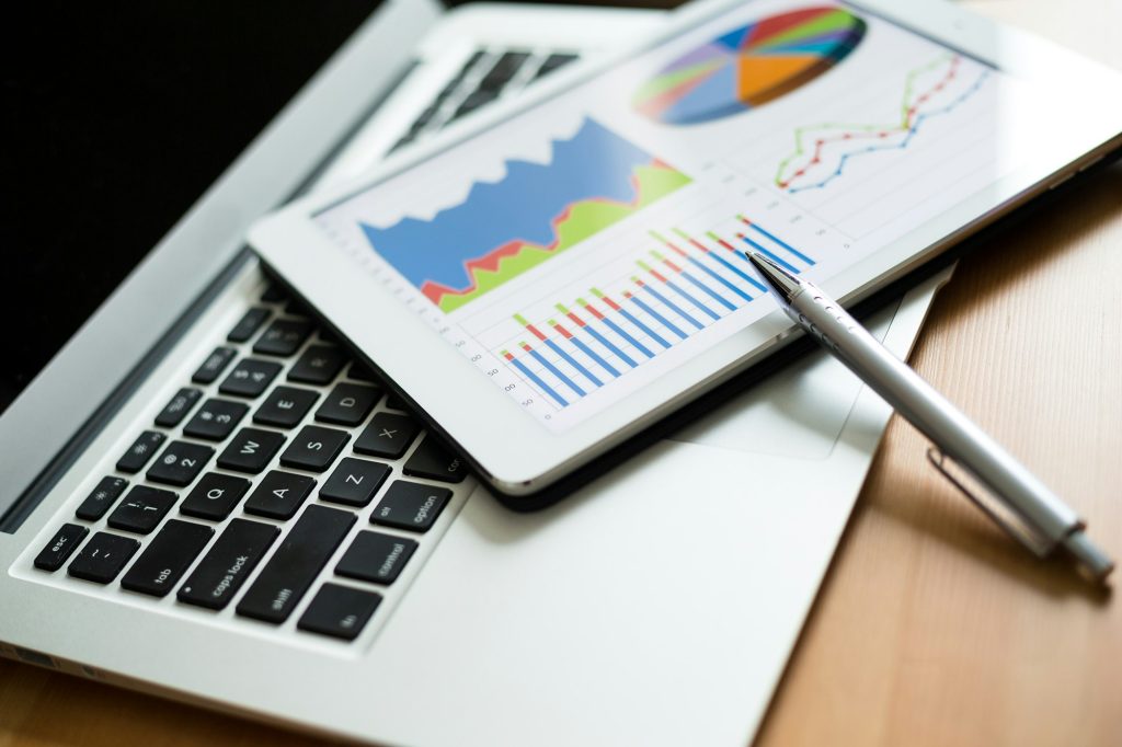 Finance Chart on tablet pc with laptop computer